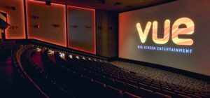 Photography of refurbished VUE cinema screen and seating at Ocean Plaza. Red LED lights and VUE logo on screen.